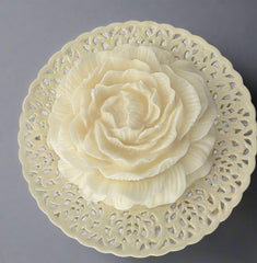 Decorative wall art with a floral design on a plain background