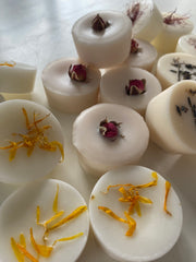 White round candies with floral elements on a white background