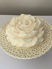 Decorative wall piece with floral design on a plain background