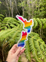 die-cut sticker shaped like the South Island of New Zealand, decorated with a rainbow stripe pattern